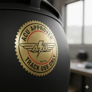 Close-up of the ACU Gold approved sticker on a motorcycle helmet indicating it is legal for track use in the United Kingdom.