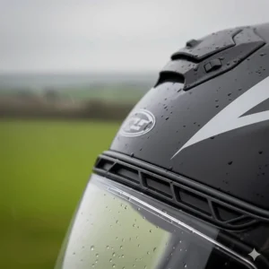 Detailed view of adjustable top vents on a motorbike helmet that can be sealed to stay watertight in heavy downpours.