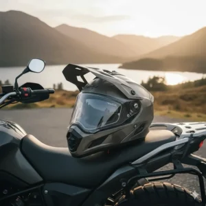 An adventure-style motorbike helmet with a Pinlock-ready visor resting on a bike in the British countryside during sunset.
