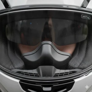Detailed internal view of a motorcycle helmet's rubber breath guard designed to deflect exhaled air away from the visor surface.