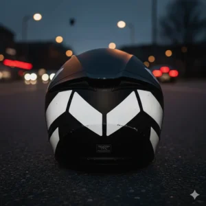Close-up of retro-reflective decals on a motorcycle helmet reflecting light in low-light conditions.