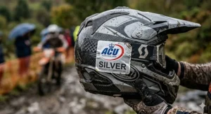 A close-up of the official ACU Silver sticker on the rear of an off-road helmet, indicating its approval for UK motocross and enduro competition.