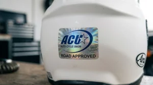 Close-up of the silver ACU sticker found on helmets suitable for road use but not sanctioned for UK competitive racing.