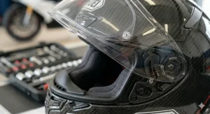Close-up of a race-spec visor featuring a Pinlock anti-fog insert and ratchet mechanism for clear visibility on UK circuits.