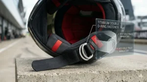 Close-up of a titanium double D-ring chin strap fastener, mandatory for MotoGP and ACU Gold sanctioned events in Britain.
