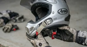 A close-up of a secure double-D ring chin strap on an ACU Silver helmet, the standard fastening system for track and off-road safety.