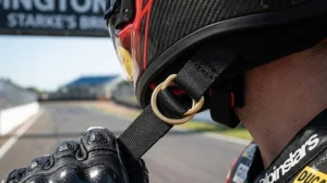 Close-up of the secure double-D ring chin strap system required for ACU Gold racing certification in the UK.