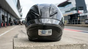 Close-up of the FIM racing homologation label on a motorcycle helmet, meeting the highest MotoGP safety standards for UK track use.