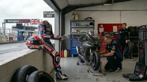Detailed view of a race-ready visor featuring adjustable posts for tear-off strips used in competitive British circuit racing.