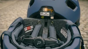 Comparison chart of various safety certified helmets under £100, ranking them by weight, airflow, and UK safety ratings.