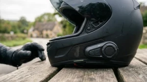 Close-up illustration of a built-in intercom system on a motorbike helmet for rider-to-pillion communication.