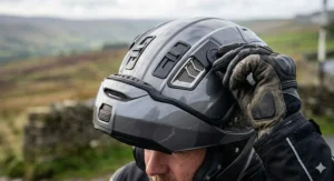 Close-up illustration of adjustable air vents on a full-face helmet designed to provide airflow during UK summer heatwaves.