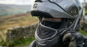 An illustration showing a removable thermal neck skirt on a motorcycle helmet to block wind chill and retain heat in freezing temperatures.