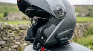 Close-up of the external Bluetooth intercom control panel attached to a motorbike helmet, highlighting the button layout for easy operation.