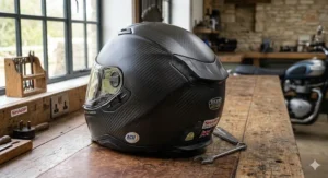 A split-view photorealistic illustration on a workshop bench showing thermal testing. One side features a fibreglass helmet under cool lighting with an infrared reading of 2.5°C, while the other shows a carbon fibre helmet reflecting heat with a reading of 12.0°C.