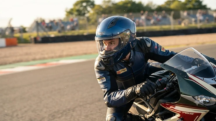A rider wearing a fibreglass sport motorcycle helmet during a track day session. fibreglass sport motorcycle helmet