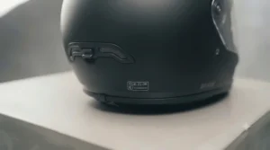 ECE 22.06 safety certification sticker on a premium fibreglass motorcycle helmet.
