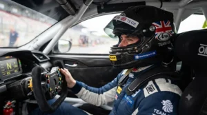 A professional driver wearing a carbon racing helmet inside a vehicle cockpit, ready for a track day.