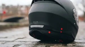A rear view of the helmet at dusk, highlighting the reflective strip on the neck roll and small red reflective studs for night visibility.