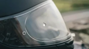Demonstrating the durable anti-scratch coating on a high-quality replacement clear helmet visor.