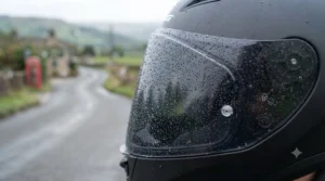 Water droplets beading off a treated smoke visor during a rainy commute in the UK.