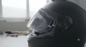 Anti-scratch and Pinlock-ready legal tinted visor for road use mounted on a modern full-face motorcycle helmet, showing the Pinlock insert and visor mechanism clearly in natural workshop light.