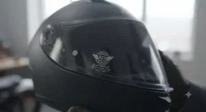 ACU Gold stamp label clearly displayed on a high-performance motorcycle helmet equipped with a legal tinted visor, indicating approval for track and road use in the UK.