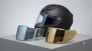 A detailed studio photograph of the matte black AGV motorcycle helmet presented on a neutral grey pedestal. In the foreground, two separate motorcycle visors are displayed on clear acrylic stands: one with a highly reflective silver mirror coating and one with a distinct, warm gold iridium coating. Both visors are angled to catch the light, clearly showing the difference in their reflective colours and hues.