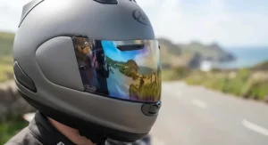 Motorbike rider wearing a multi-colour rainbow iridium visor for daytime glare reduction
