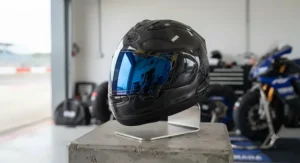 Blue mirrored replacement visor mounted on a sleek full-face sports helmet for track-day use.