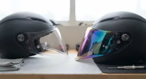 Side-by-side comparison of a standard clear visor versus an iridescent mirror visor for circuit racing.