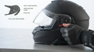 Hands using the quick-release mechanism to install a new transitions visor on a motorcycle helmet.