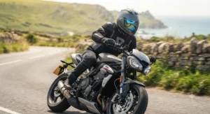 Motorcyclist riding a sports bike on a UK road during a sunny afternoon wearing an iridium visor