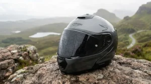 A touring motorcycle parked against a backdrop of variable British weather, highlighting the need for adaptable gear.