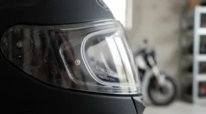 A close-up view of a pinlock anti-fog insert correctly installed on a clear motorcycle helmet visor.
