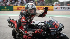 Fast action pulling a tab to remove tear-off laminates for helmet visor visibility during high-speed racing